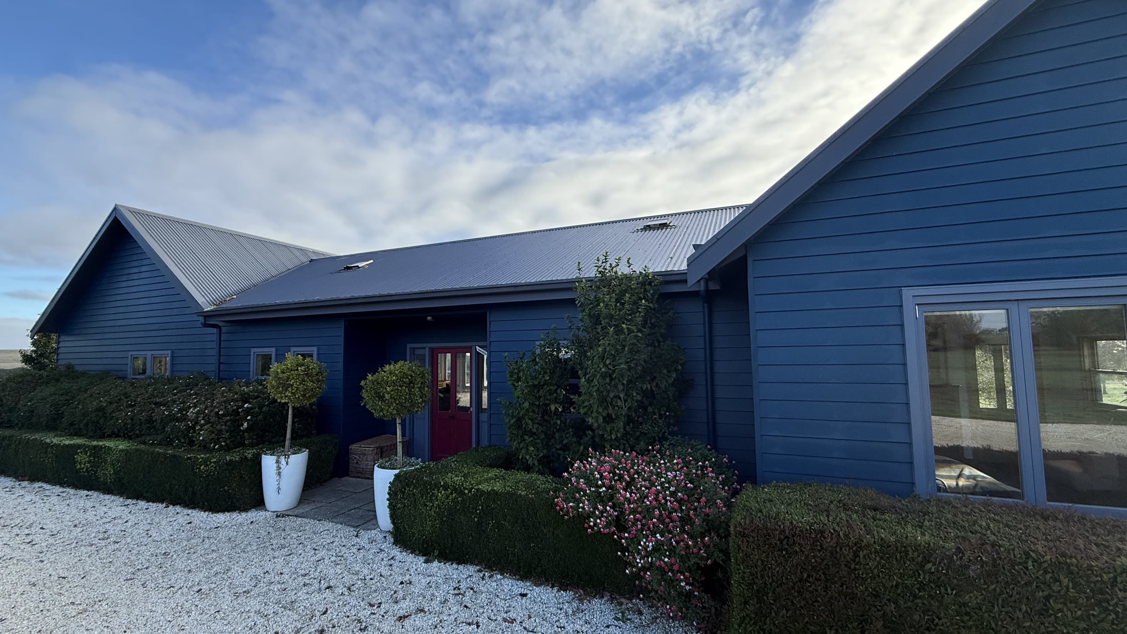 A maintained, freshly painted coastal home exterior