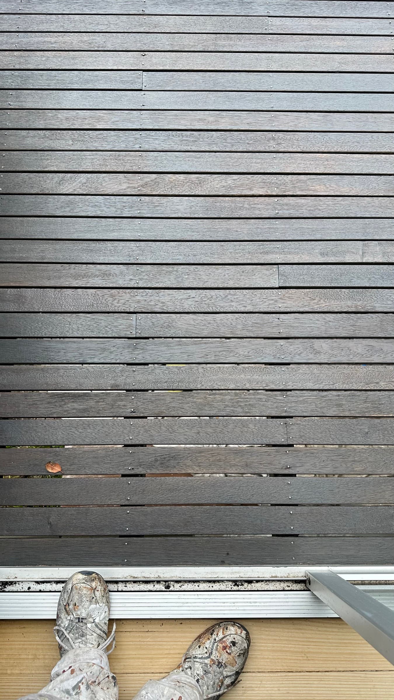 A greyed, salt-weathered timber surface on a coastal home